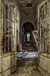 Man standing behind glass door of abandoned house