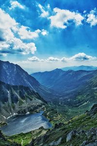 Scenic view of mountains against cloudy sky