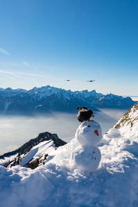 Scenic view of snowcapped mountain against blue sky