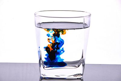 Close-up of multi colored water against white background