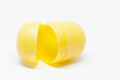 Close-up of yellow object over white background