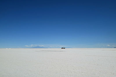 Scenic view of desert against blue sky