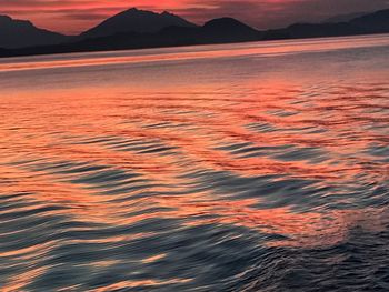 Scenic view of sea against orange sky