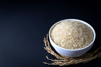 High angle view of bread in bowl against black background
