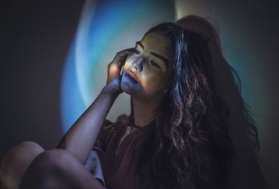 Portrait of young woman looking away at home