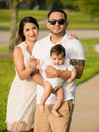 Portrait of family standing in park