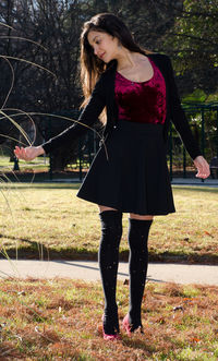 Smiling young woman standing outdoors