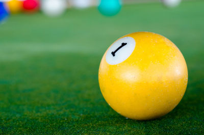 Close-up of yellow ball on pool table