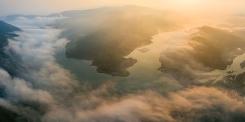 Aerial view of mountains against sky during sunset