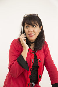 Portrait of smiling young woman against white background