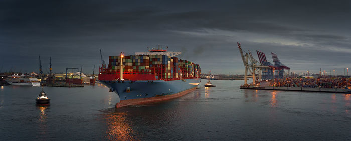 Commercial dock by sea against sky