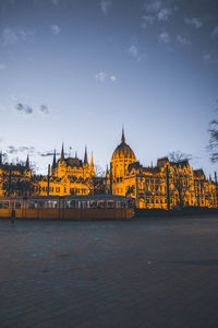 View of temple building against sky with city in background