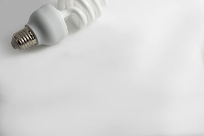 Close-up of light bulb against white background