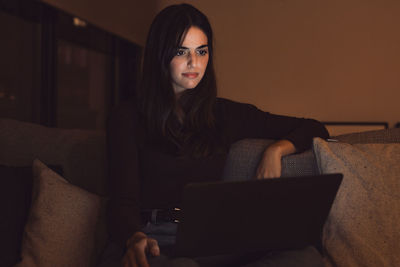 Young woman using laptop at home