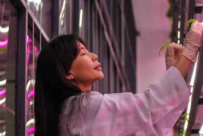 Dominique alexandra checking her indoor plants with the controlled environment agriculture system