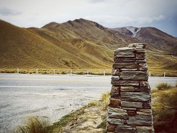 Empty road against hills