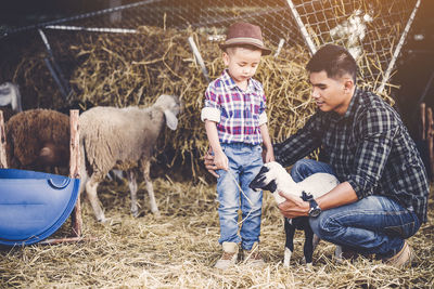 Full length of people and daughter in farm