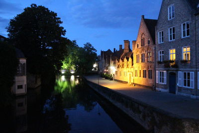 Illuminated buildings against sky at night