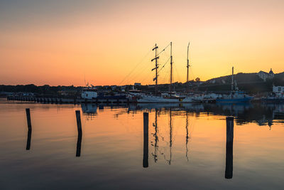 Sailboats in marina at sunset