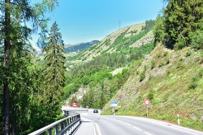 Road amidst mountains against clear sky