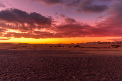 Scenic view of desert against sky during sunset