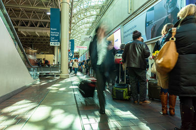 Rear view of people walking in city