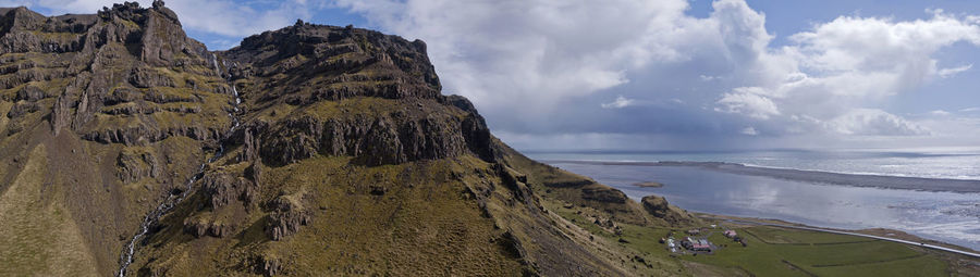 Panoramic view of sea and mountains against sky