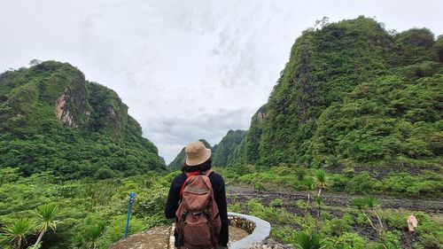 Rear view of woman walking on mountain