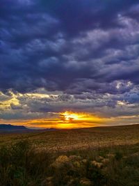 Scenic view of landscape against cloudy sky