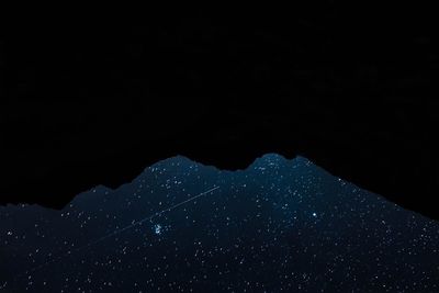 Aerial view of illuminated lights against clear sky at night