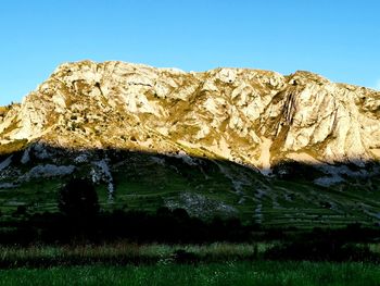 Scenic view of rocky mountains against clear blue sky