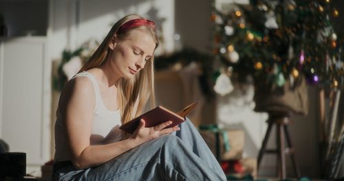 Young woman using mobile phone at home