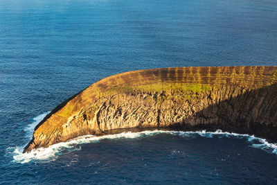 Aerial view of rock formation in sea