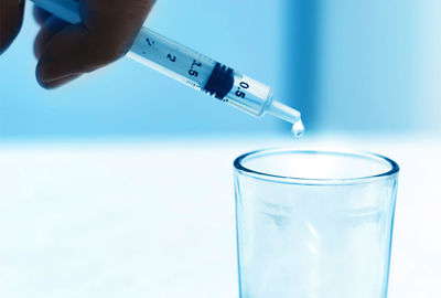 Close-up of hand holding glass of water