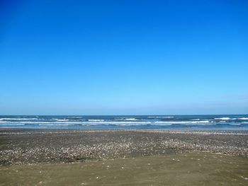 Scenic view of sea against clear blue sky