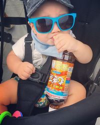 Portrait of boy playing with sunglasses