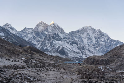 Scenic view of snowcapped mountains against clear sky