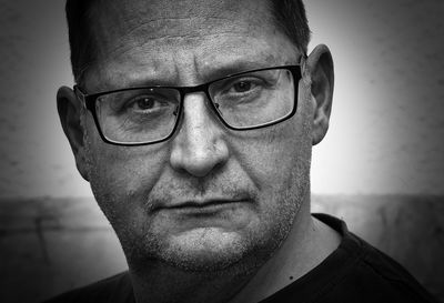 Close-up portrait of man wearing eyeglasses