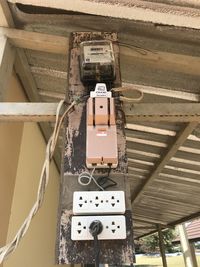 Low angle view of telephone booth on wall