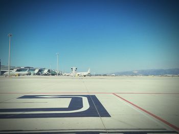 Road against clear blue sky