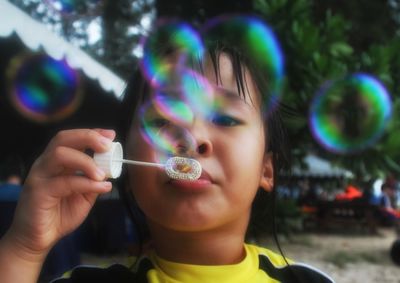 Close-up of girl holding bubbles