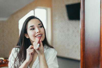 Portrait of smiling young woman at home