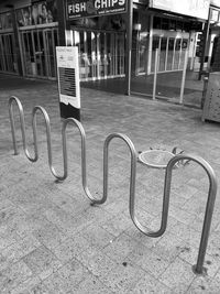 Bicycle sign on railing in city