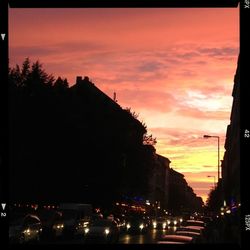 Traffic on road at sunset