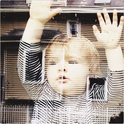 Double exposure image of baby and blinds window