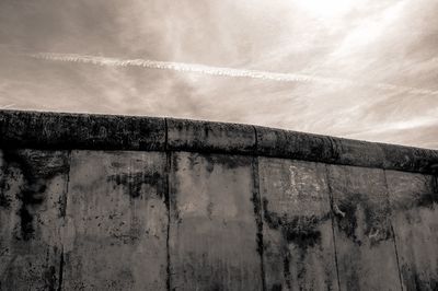 Weathered wall against cloudy sky