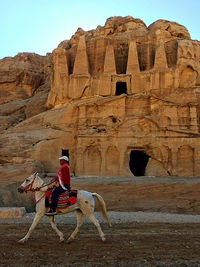 Man riding bicycle on rock
