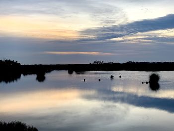 Scenic view of lake against sky during sunset