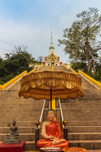 Portrait of man sitting on temple