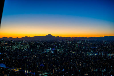 Aerial view of townscape against sky during sunset